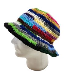 a white mannequin head wearing a multicolored hat