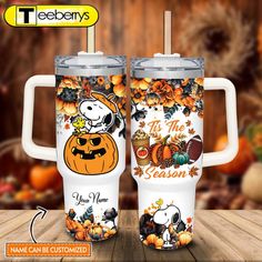 two coffee mugs with snoopy and pumpkins on them, both decorated with the words it's the season