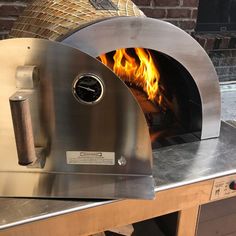 a pizza oven with fire burning inside of it