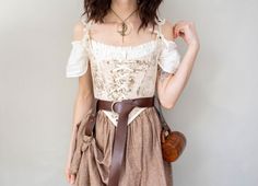 This ivory and light brown renaissance bodice features a whimsical 17th century pastoral scene. The low scoop neckline accentuates the bust, and an extra pointy waistline delicately narrows the waist. Peasant Bodice, Corset Fabric, French Meadows, 18th Century Stays, Peasant Costume, Brown Toile, Renn Faire, Ren Faire Outfits, Ren Faire Costume