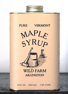 a can of maple syrup sitting on top of a table