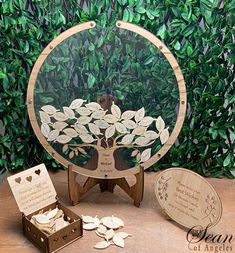 a wooden stand with a tree cut out in the center and some leaves scattered around it