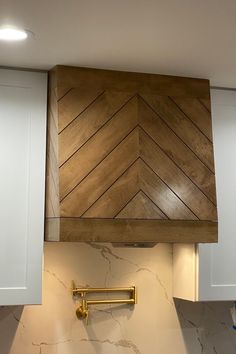 a stove top oven sitting inside of a kitchen next to white cabinets and counter tops