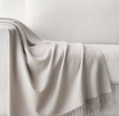 a white bed with a blanket on top of it