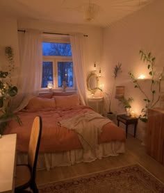 a bed room with a neatly made bed next to a desk and window at night