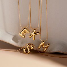 Show off your unique style with our Pippa Bubble Initial Pendant! This bold gold necklace features a bubble letter charm that proudly showcases your first or last initial. Make a statement with this fun and playful accessory. Get yours now and make your outfit pop! Available in 14k gold plated brass 15" snake chain with 2" extender Initial size: 13/16" tall, width varies Lobster claw closure Protected with an anti-tarnish barrier SKU: BYN1520 Initial Chain Letter Necklace, Bubble Letter Necklace, Tennis Jewelry, Chain Letter, Initial S, Modern Jewellery Design, Bubble Letter, Initial Necklaces, Necklace Name