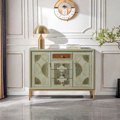 a white and gold sideboard with a clock on the wall