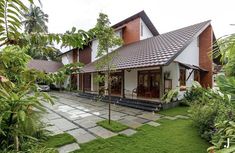 the house is surrounded by lush green plants