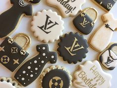 decorated cookies with black and white designs are arranged on a table top for a birthday party