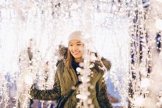 a woman standing in front of a display of snowflakes and icicles