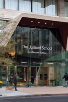 people walking in front of the juliard school building