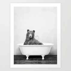 a black and white photo of a bear in a bathtub