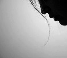 black and white photograph of a woman's face with her hair blowing in the wind