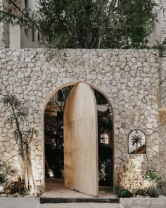 an entrance to a stone building with a wooden door