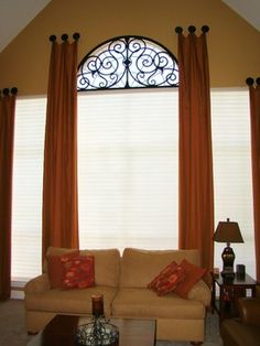 a living room with two couches and a coffee table in front of the window