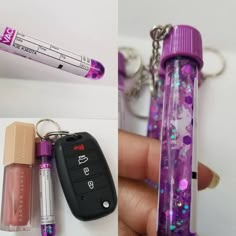 a person holding a cell phone and keychain with some glitter on the keys