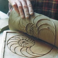 a person is working with clay on a table