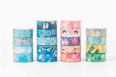 five different colored washi tapes stacked on top of each other in various sizes and shapes