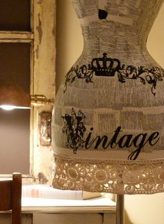 an old fashion dress made out of newspaper with the word vintage on it's back