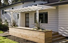 a white house with a wooden planter outside