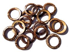 several wooden rings sitting on top of each other in the middle of a white surface