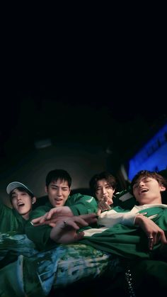 group of young men standing together in the dark