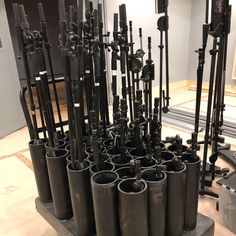 a bunch of black vases sitting on top of a table