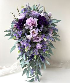 a bouquet of purple flowers and greenery