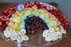 a rainbow shaped fruit platter on a table