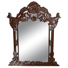 an ornately carved wooden mirror is shown