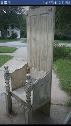 an old wooden chair sitting on top of a sidewalk