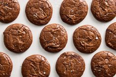 chocolate cookies are lined up on a baking sheet and ready to be baked in the oven