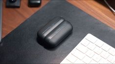 a black mouse pad sitting on top of a desk next to a keyboard and monitor