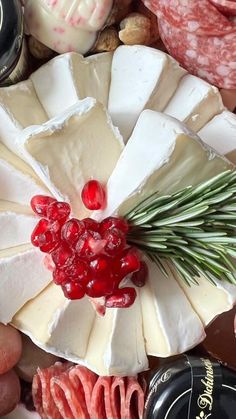 several different types of cheese and meats on a table