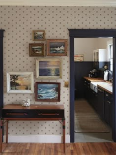 an entry way with pictures and paintings on the wall