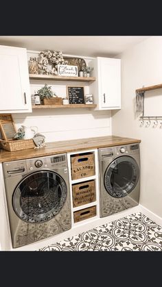 a small laundry room with two washers and dryer