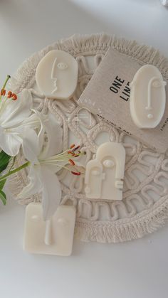 some soaps and flowers on a white plate