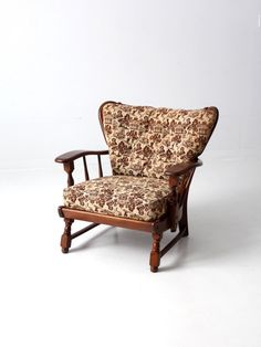 an old fashioned chair with floral upholstered fabric