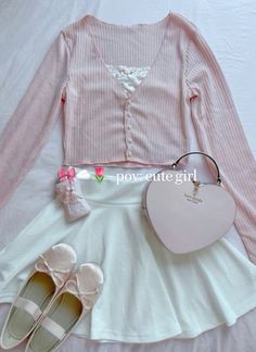 a white dress and pink shoes are on the bed next to a heart shaped purse