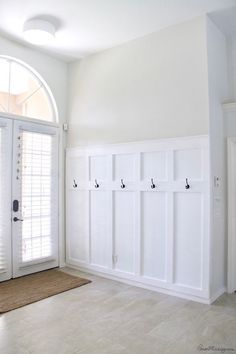 an empty room with white walls and doors