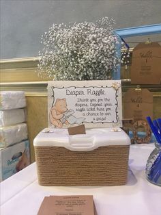 a winnie the pooh diaper raffle box with baby's breath in it