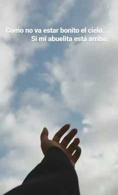 a hand reaching up into the sky with clouds in the background