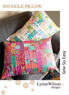 a pillow made out of colorful patchwork on a couch with the words snuggle pillow