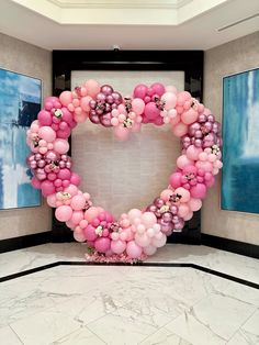 a heart shaped balloon decoration in the middle of a room