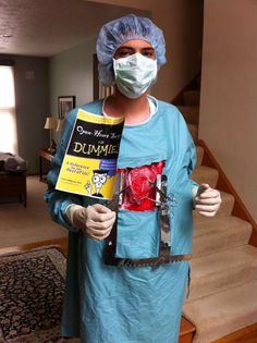 a person in scrubs holding up a book