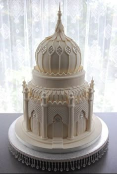 a large white cake sitting on top of a table