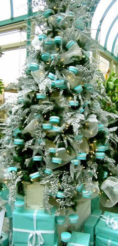 a christmas tree decorated with blue and silver presents