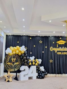 balloons and decorations in front of a backdrop for an graduation party with the number 24 on it