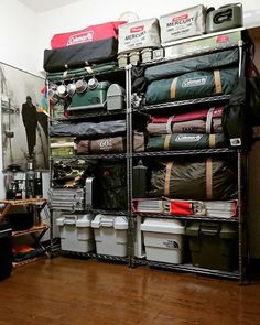 an organized storage rack in a room with wood flooring and various items on it