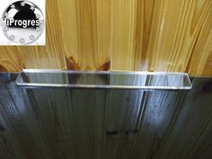 an image of a bathroom with wood paneling on the wall and glass in the shower